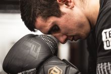 Man Looking Down Wearing Boxing Gloves