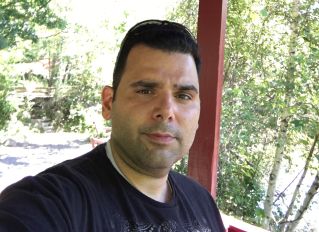 Man in Black Shirt and Pants Standing on the Floor